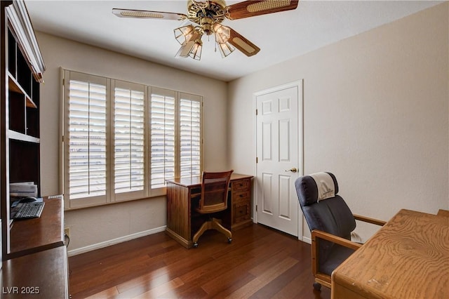 office space featuring baseboards, a ceiling fan, and dark wood-type flooring