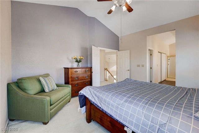 carpeted bedroom featuring ceiling fan and high vaulted ceiling