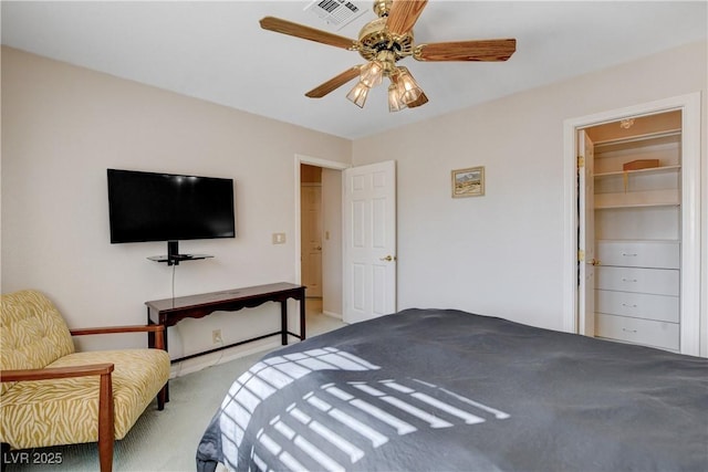 bedroom featuring a ceiling fan, visible vents, and light carpet