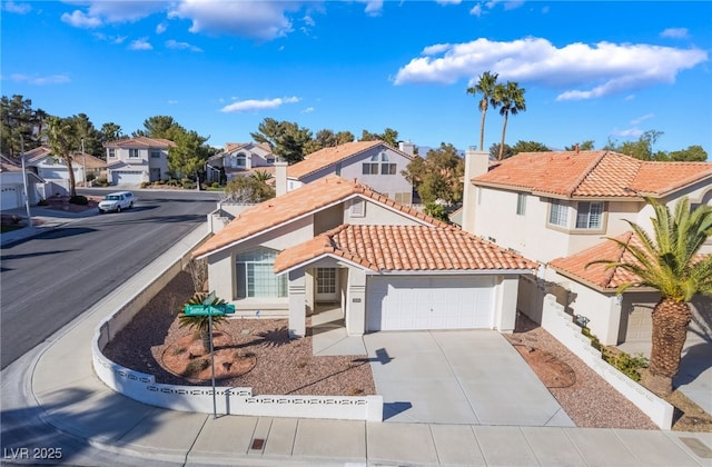 mediterranean / spanish home featuring stucco siding, concrete driveway, a garage, a residential view, and a tiled roof