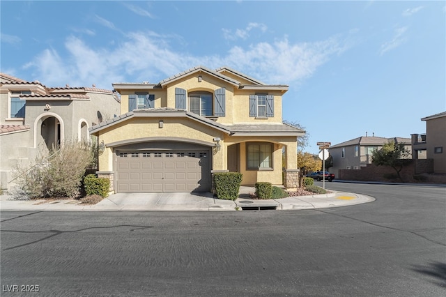 mediterranean / spanish-style home with concrete driveway and stucco siding