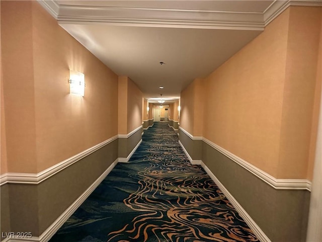 hall featuring carpet, crown molding, and baseboards