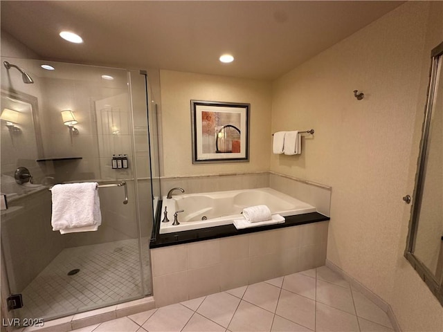 bathroom with a stall shower, a garden tub, recessed lighting, and tile patterned floors