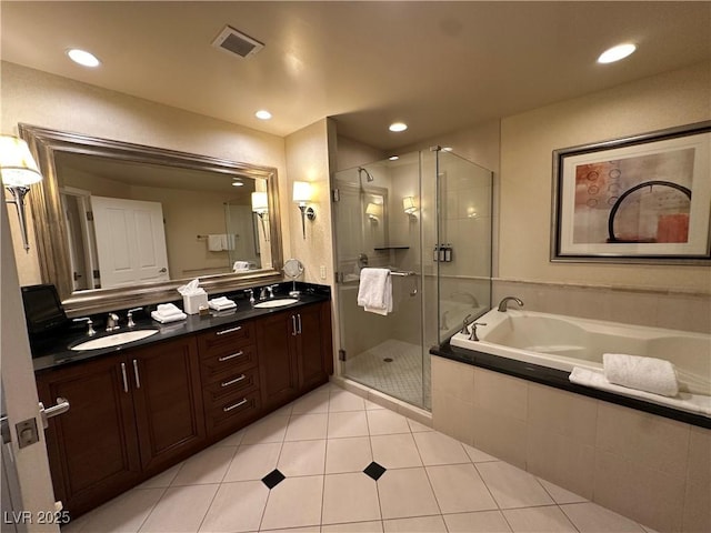 full bathroom featuring double vanity, a shower stall, visible vents, and a sink