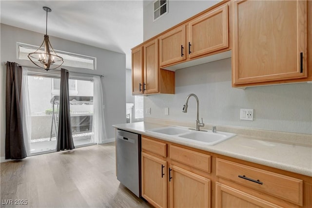 kitchen with visible vents, light countertops, light brown cabinetry, stainless steel dishwasher, and a sink