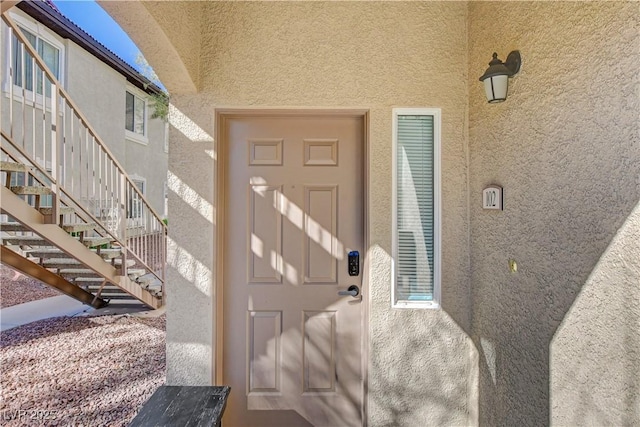 property entrance with stucco siding