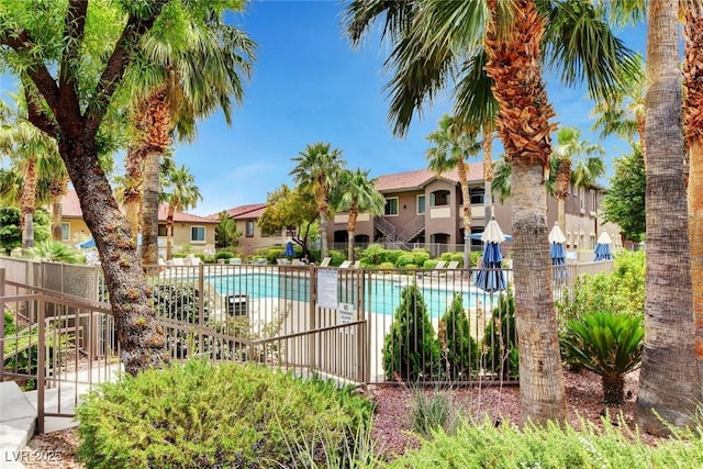 pool with fence and a residential view