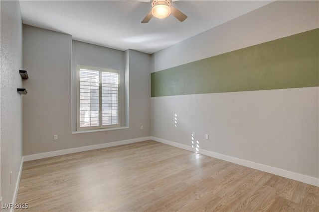 unfurnished room featuring ceiling fan, light wood-type flooring, and baseboards