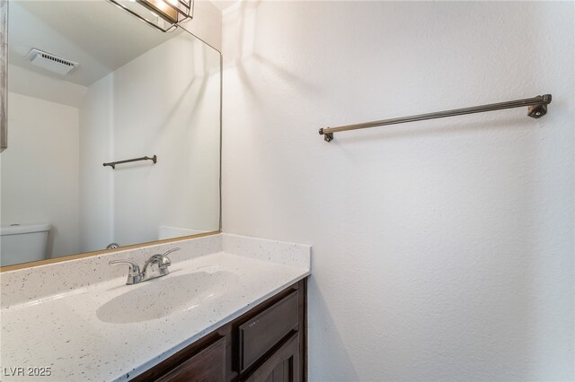 2667 Aracatuba Ave, Las Vegas, NV 89121 - half bath with toilet, visible vents, and vanity