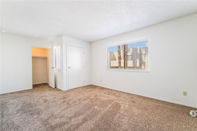 2667 Aracatuba Ave, Las Vegas, NV 89121 - unfurnished bedroom featuring carpet flooring, a textured ceiling, baseboards, and a closet