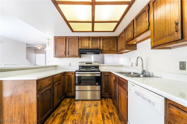 2667 Aracatuba Ave, Las Vegas, NV 89121 - kitchen with a sink, stainless steel range with electric stovetop, dishwasher, a peninsula, and under cabinet range hood