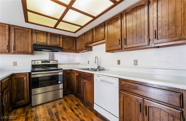 2667 Aracatuba Ave, Las Vegas, NV 89121 - kitchen featuring white dishwasher, under cabinet range hood, a sink, dark wood finished floors, and stainless steel electric range oven
