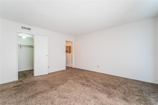 2667 Aracatuba Ave, Las Vegas, NV 89121 - unfurnished bedroom with carpet floors, visible vents, a spacious closet, and a closet