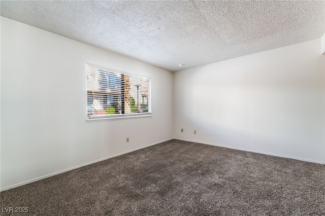 2667 Aracatuba Ave, Las Vegas, NV 89121 - spare room featuring baseboards, dark carpet, and a textured ceiling