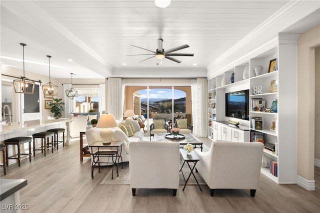 living room featuring built in shelves, a ceiling fan, light wood-style flooring, ornamental molding, and wood ceiling