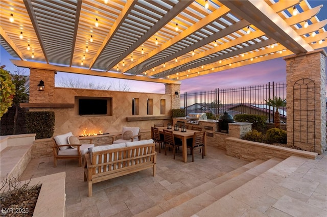 view of patio with area for grilling, a grill, fence, and an outdoor hangout area