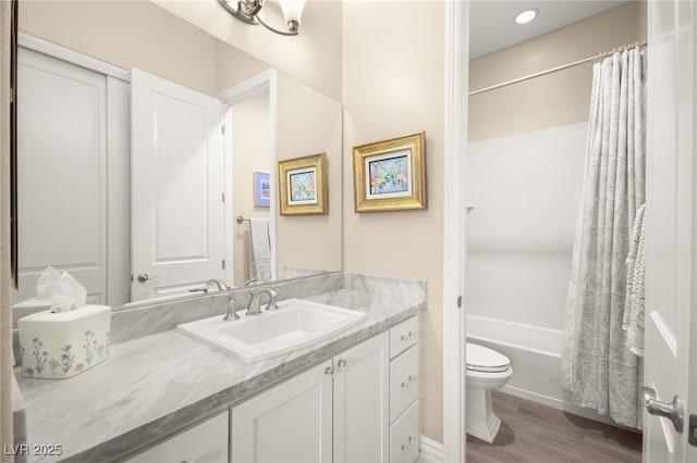 bathroom with toilet, vanity, shower / tub combo, and wood finished floors