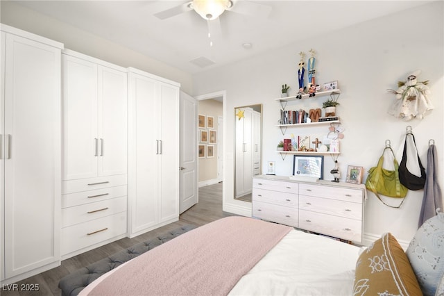 bedroom featuring wood finished floors, baseboards, and ceiling fan