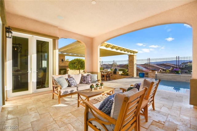 view of patio / terrace featuring outdoor lounge area, fence, and french doors