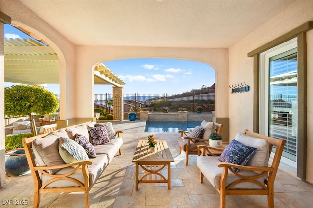 view of patio featuring outdoor lounge area, fence, and a pergola