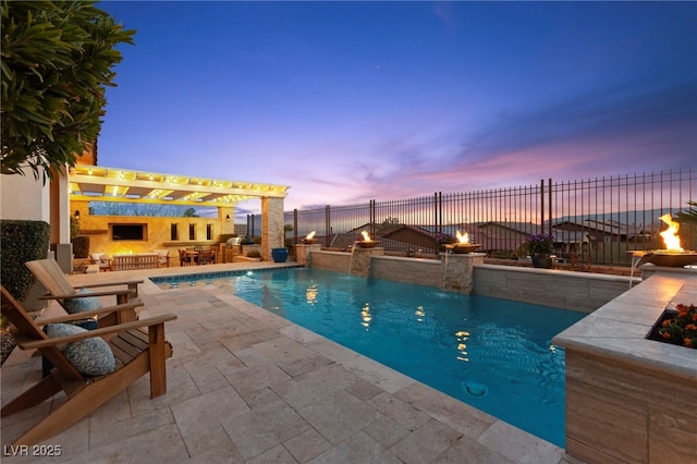 view of pool with exterior fireplace, a pergola, fence, a fenced in pool, and a patio area