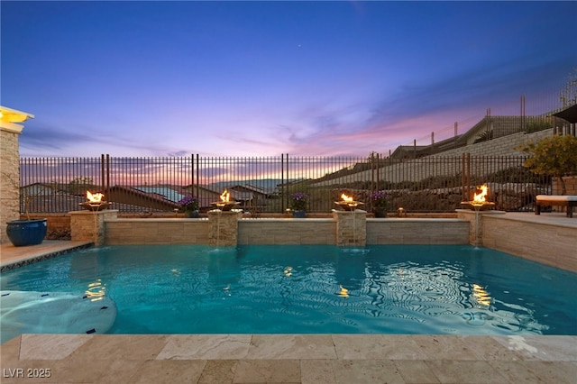 pool at dusk with fence and a fenced in pool