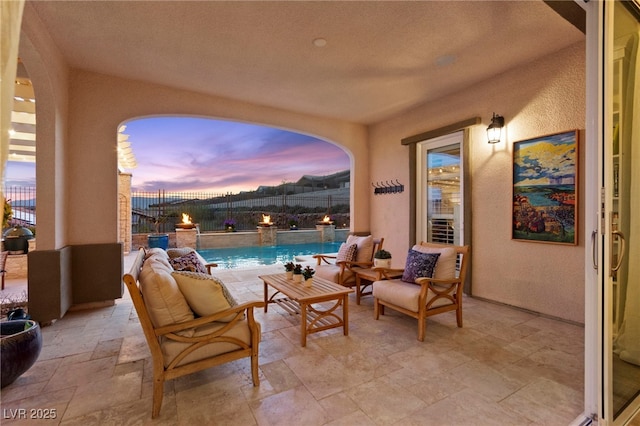 patio terrace at dusk featuring outdoor lounge area, area for grilling, a fenced backyard, and a fenced in pool