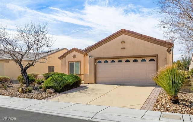 mediterranean / spanish-style house with an attached garage, a tile roof, concrete driveway, and stucco siding