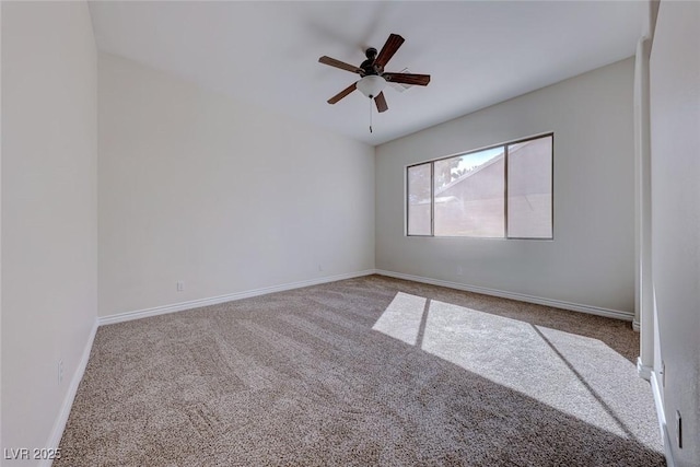 spare room featuring carpet floors, baseboards, and a ceiling fan