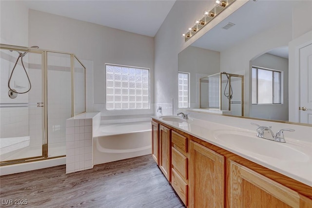 full bathroom with plenty of natural light, a sink, and a bath