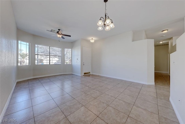 empty room with light tile patterned floors, visible vents, baseboards, and ceiling fan with notable chandelier