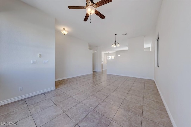 unfurnished room featuring light tile patterned floors, visible vents, baseboards, and ceiling fan with notable chandelier