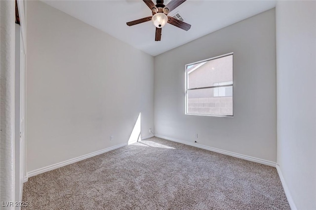 spare room with light colored carpet, ceiling fan, visible vents, and baseboards