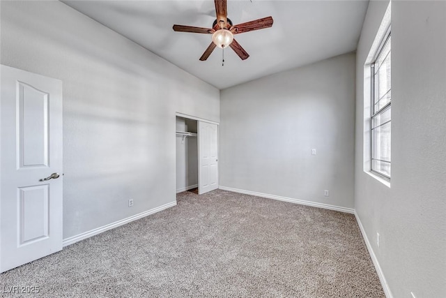 unfurnished bedroom with a closet, carpet flooring, ceiling fan, and baseboards