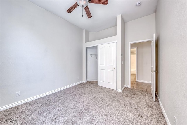 unfurnished bedroom featuring a ceiling fan, baseboards, a closet, and light colored carpet