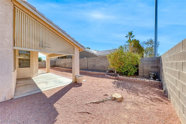 view of yard featuring a patio area and a fenced backyard