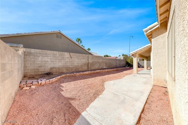 view of yard with a patio area and a fenced backyard