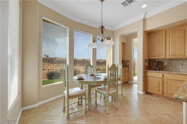 dining space featuring light tile patterned floors, visible vents, baseboards, and crown molding