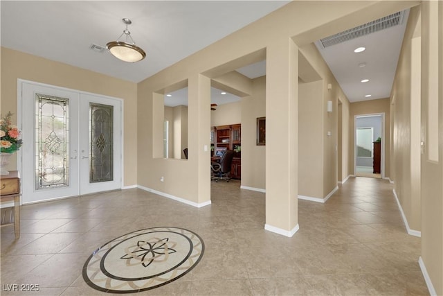 entryway with visible vents, french doors, and baseboards