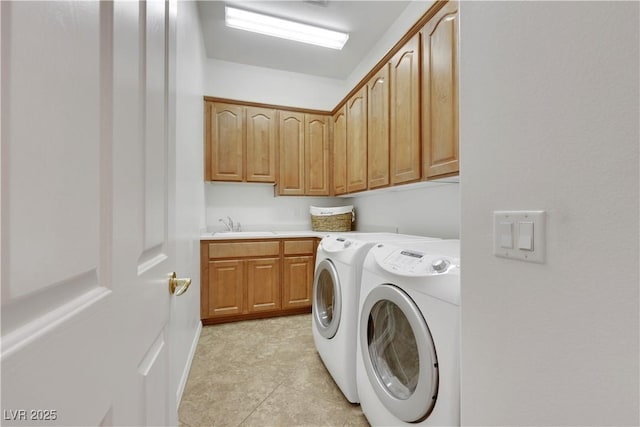 laundry area with cabinet space, independent washer and dryer, and a sink