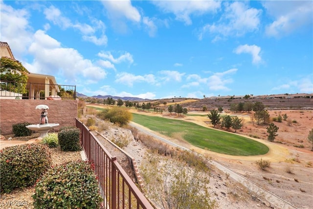 view of property's community with view of golf course and fence