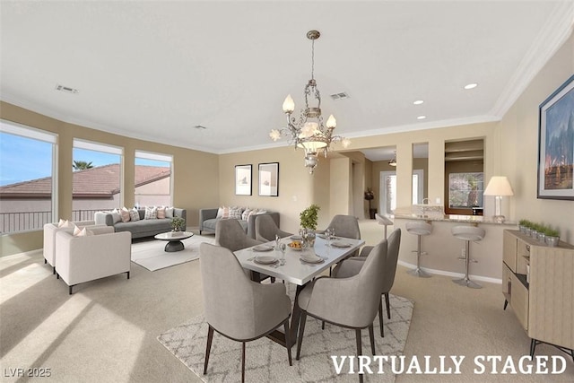 dining room featuring visible vents, light carpet, baseboards, and ornamental molding