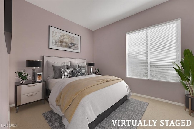 bedroom with baseboards and light carpet