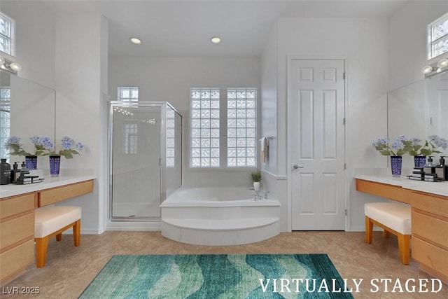 full bathroom with a bath, plenty of natural light, and a shower stall