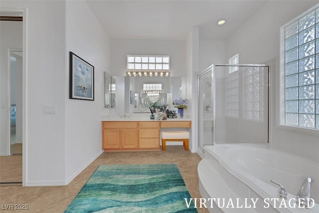 bathroom with plenty of natural light, a stall shower, vanity, and a bath