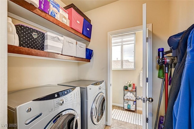 laundry area with washer and clothes dryer, laundry area, and light tile patterned flooring