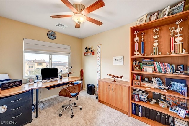 office area featuring visible vents, ceiling fan, and carpet