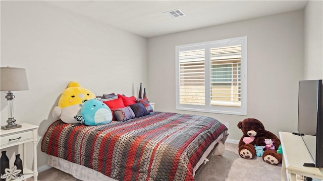 carpeted bedroom featuring baseboards and visible vents