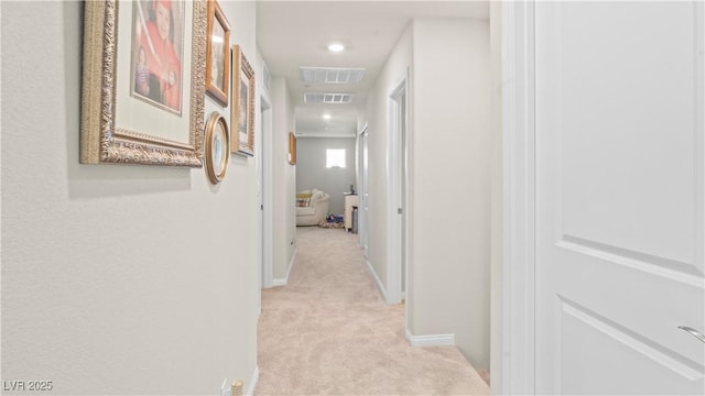 corridor featuring baseboards, recessed lighting, visible vents, and light colored carpet