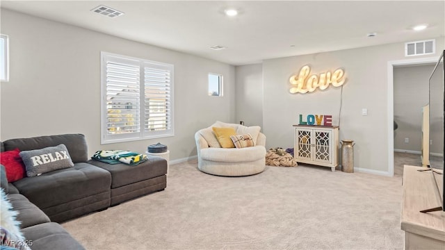 living area featuring carpet floors, baseboards, and visible vents